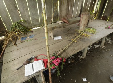 Bibles, flowers, a drum and a microphone are seen inside the improvised temple where a pregnant woman, five of her children and a neighbour were killed in a religious ritual.