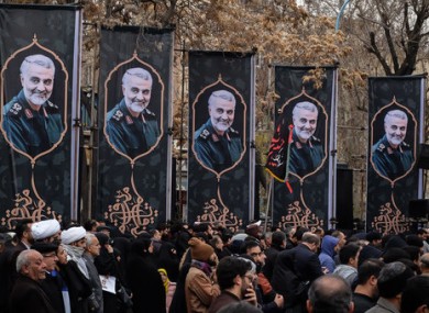 Iranians take part in a rally to protest the killing in Tehran.