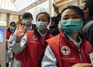 Medical workers wave goodbye at Changshui International Airport in Kunming.