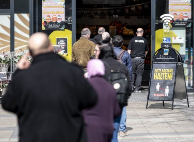 Long queues for supermarkets, like this one in Berlin, is replicated in many parts of the world.