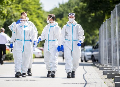 Soldiers in protective suits and wearing mouth-and-nose masks go to the homes to test more people for the coronavirus.