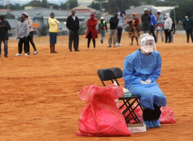 A medic waits for a patient to test for Covid-19 in the Alexandra township in South Africa.