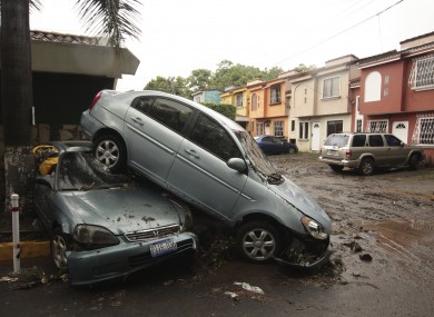 Vehicles stand damaged by an Acelhuate River flash flood at a neighborhood in San Salvador, El Salvado