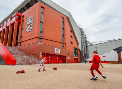 James Ryan-Byrne (red kit) and Ethan Potsig, both aged nine, play football outside Anfield.