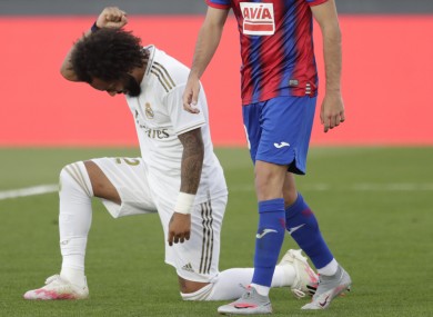 Real Madrid's Marcelo kneels as he celebrates his goal.