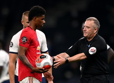 Jon Moss takes the ball from Marcus Rashford after United's second penalty was overturned by VAR late on.