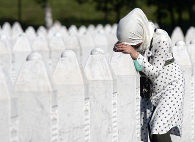 A woman by a grave stone in Potocari, near Srebrenica, Bosnia today.
