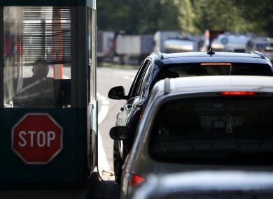 People in cars wait at the Horgos border crossing into Hungary from Serbia.