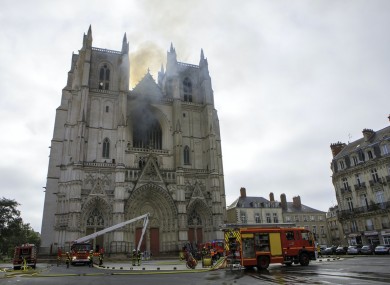 Firefighters working to extinguish the blaze at the Gothic St Peter and St. Paul Cathedral in Nantes, western France