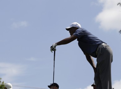 Woods winces as he watches his shot in the second round of the Memorial tournament.