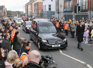 People line the streets as the funeral cortege of Noah Donohoe enters Saint Malachy's College in Belfast where the teenager went to school, following his private funeral service at Saint Patrick's Church.