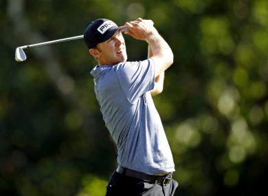 Power watches his tee shot on the 9th.