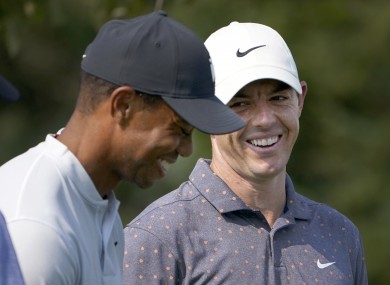 Rory McIlroy, right, looks at Tiger Woods and laughs during a practice round.