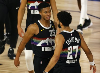 Jamal Murray (right) and team-mate PJ Dozier celebrate the Denver Nuggets’ stirring come-from-behind win which kept their post-season alive against the Utah Jazz.