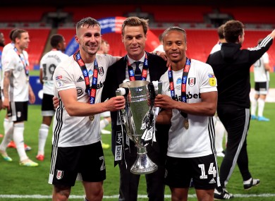 Fulham’s Joe Bryan, manager Scott Parker and Bobby Decordova-Reid celebrate with the trophy.