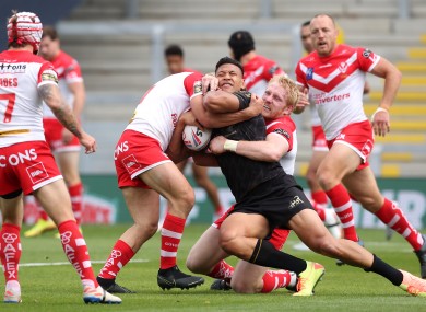 Catalan Dragons' Israel Folau is tackled by St Helens' James Bentley (left) and James Graham during the Betfred Super League match.