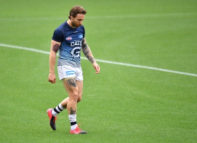 Tuohy walks out of Geelong's warm-up ahead of the match against Essendon.