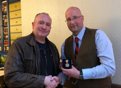 Gerard ‘Del’ Delaney presenting James Murray’s victory medal to James’s great grandson Dr John Murray