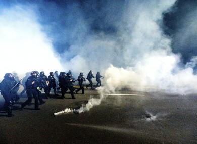 Police use chemical irritants and crowd control munitions to disperse protesters during a demonstration in Portland, Oregon