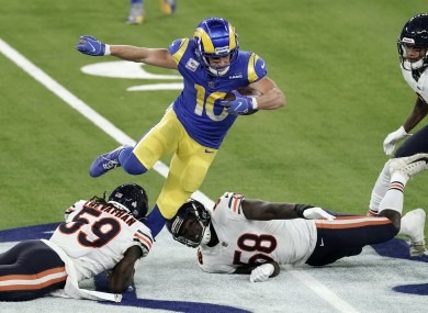 Rams wide receiver Cooper Kupp, top, leaps over Bears inside linebacker Danny Trevathan (59).