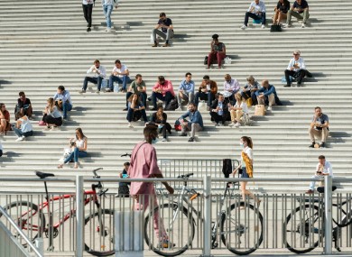 People on the steps of La Grande Arche in France last month.