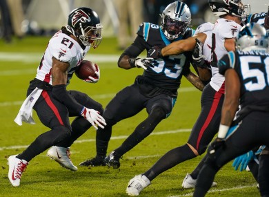 Atlanta Falcons running back Todd Gurley (21) runs for yardage chased by Carolina Panthers defensive end Brian Burns (53).