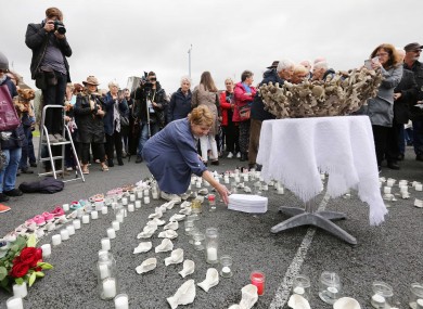 Historian Catherine Corless places a 'baby's coffin' at a temporary shrine to the babies who died in the Tuam mother and baby home. 2018.