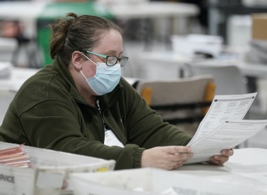 Poll worker examines ballots during the 2020 US election
