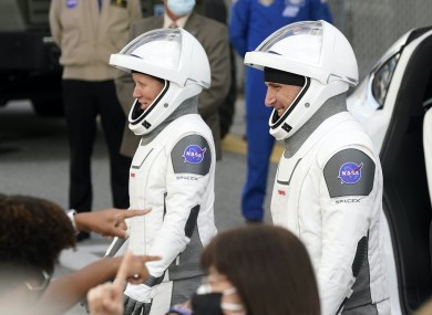 NASA astronauts Shannon Walker, left, and Michael Hopkins smile at family members as they leave for the SpaceX Crew-1 mission to the International Space Station