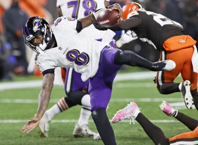 Baltimore Ravens quarterback Lamar Jackson rushes for a 5-yard touchdown during the first half of an NFL football game against the Cleveland Browns
