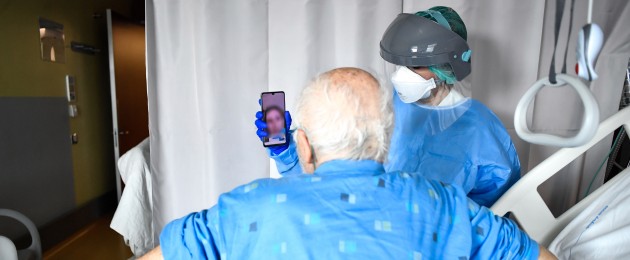 A Covid-19 patient makes a video call at a hospital in Italy (File photo)