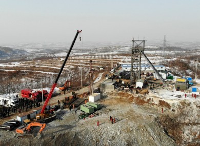 Rescuers work at the site of a gold mine that suffered an explosion in Qixia in eastern China’s Shandong Province