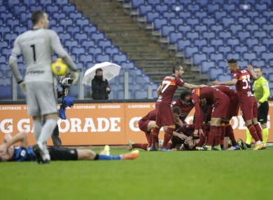 Roma's Gianluca Mancini is celebrated by teammates after his later leveller.