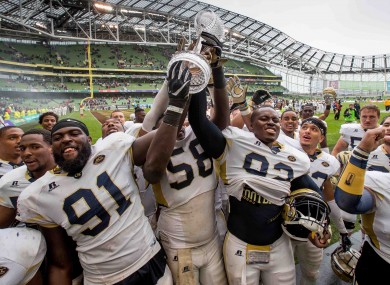 Georgia Tech players celebrate with the Keough-Naughton trophy after the 2016 fixture in Dublin.