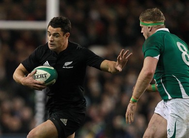 Dan Carter under pressure from Jamie Heaslip during a November 2010 Test between New Zealand and Ireland.