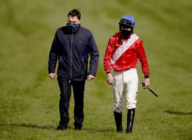 Jockey Jack Kennedy is met by trainer Henry de Bromhead after falling from Envoi Allen.