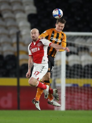 Hull City's Sean McLoughlin wins a header against Paddy Madden of Fleetwood Town.