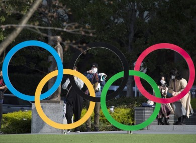 People taking pictures of the Olympic rings installed by the Japan Olympic Museum in Tokyo.