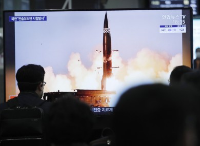 People watch a TV showing an image of North Korea's new guided missile at a train station in Seoul, South Korea.