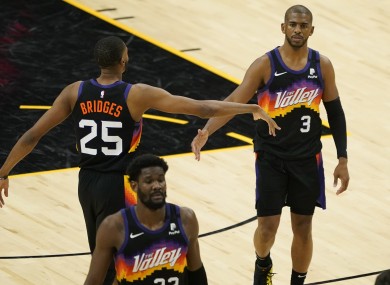 Phoenix Suns guard Chris Paul (3) is greeted by teammate forward Mikal Bridges (25) during the game.