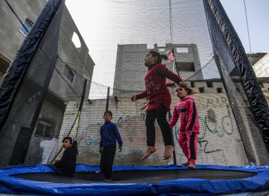 Palestinian children play on a street, in the Jabalia Palestinian refugee camp in the northern Gaza Strip