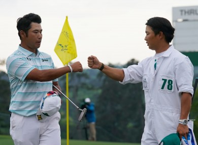 Matsuyama is congratulated by caddie Shota Hayafuji after a third-round 65.