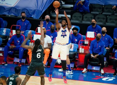 Joel Embiid, right, goes up for a shot against DeAndre Jordan.