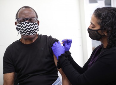 Pharmacist Asha Fowells vaccinates Paul Jinadu, 79.
