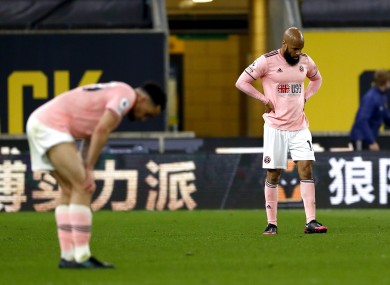 David McGoldrick is dejected as Sheffield United's return to the Championship is confirmed.