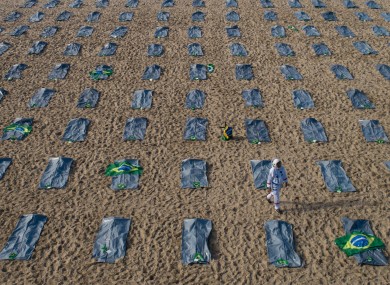 Protestors line Copacabana beach with empty bodybags to highlight Brazilian President Jair Bolsonaro's handling of the crisis