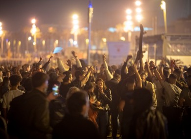 Crowds of people dance on the beach in Barcelona