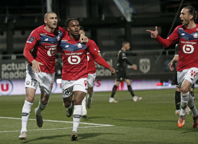Burak Yilmaz, left, celebrates with Renato Sanches after scoring Lille's second goal.
