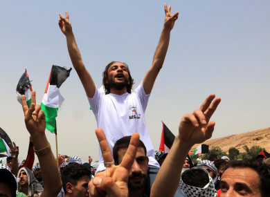 People celebrate the ceasefire between Israel and Hamas near the Al-Karama area in the Jordan Valley, Jordan, yesterday.