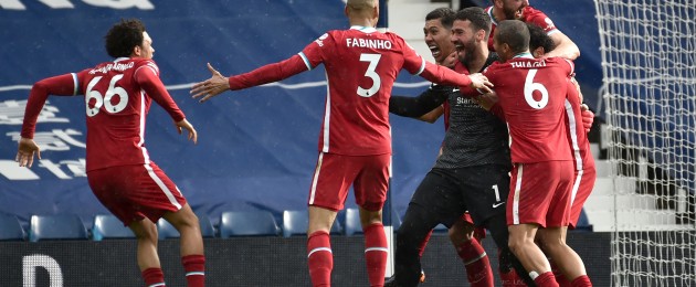 Alisson is mobbed in celebration after scoring.